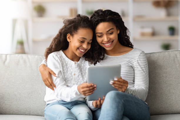 istock Happy african american mother and kid using digital tablet together 1322907015