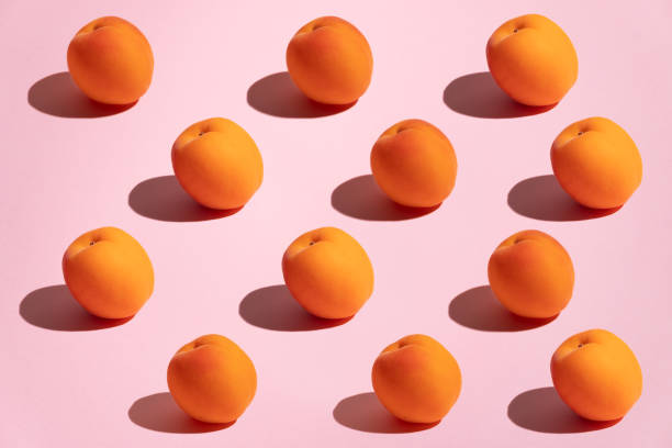 Pattern of apricots on pink background