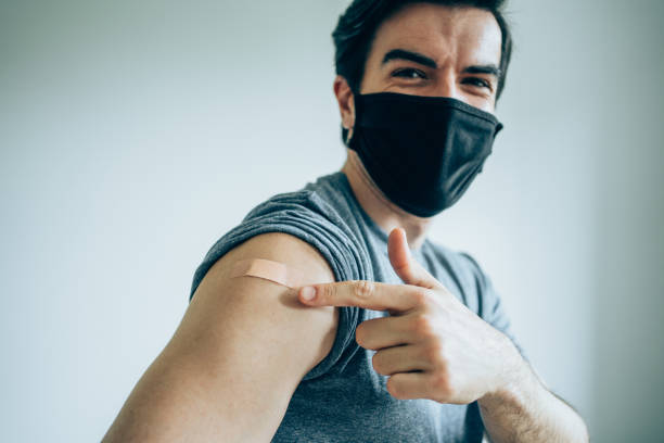 istock Man showing his arm after getting vaccinated. 1322908267