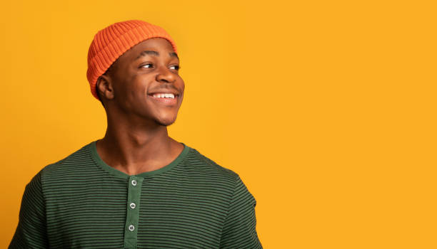 istock Cheerful Young Black Guy In Hat Looking At Copy Space With Interest 1322908670