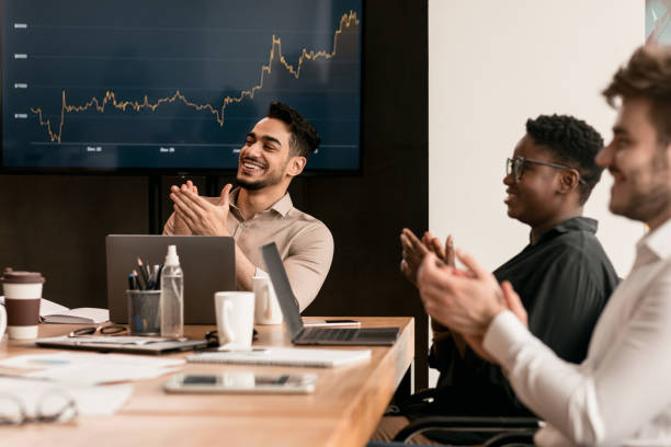 istock Colleagues having meeting in boardroom, clapping hands 1322909445