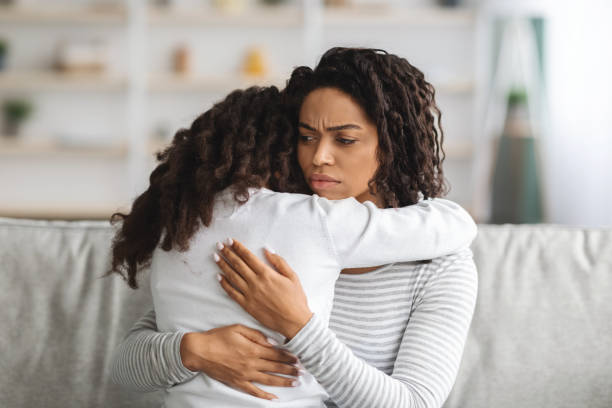 istock Indignant black mother hugging her daughter, closeup 1322909514