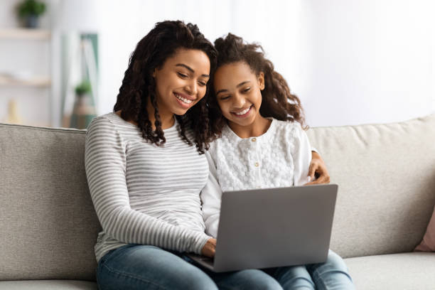 istock Happy african american mother and kid using laptop together 1322909949
