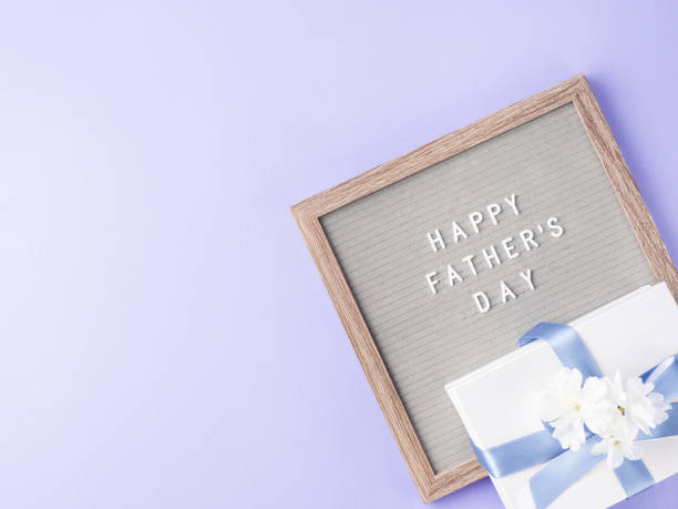 istock Happy fathers day greeting card with letter board and present 1322909979