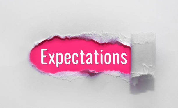 istock inscription Expectations word on blue torn papper 1322910961