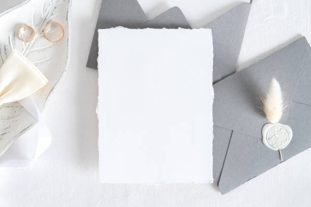 istock Wedding invitation card mockup, grey envelopes, rings on white background. Flat lay, top view. Minimal style. 1322911609