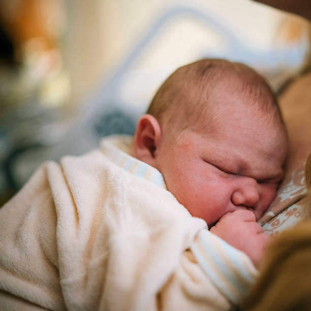 istock View of newborn sleeping on mother's chest 1322913877