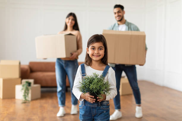 istock Happy young family packing or unpacking boxes 1322915236