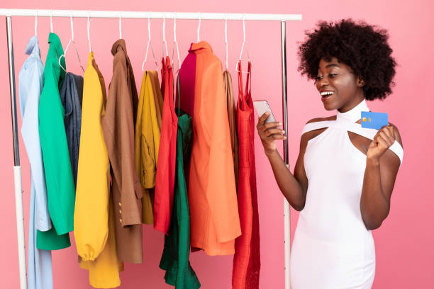 istock Black Woman Using Smartphone With Mobile Shopping Application, Pink Background 1322915306
