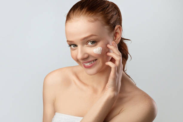 istock Young Lady With Heart-Shaped Cream On Cheek Posing In Studio 1322916615