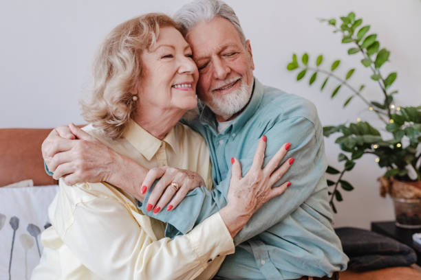 istock Senior couple is embracing at home 1322918143