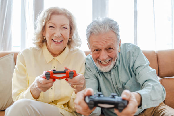 istock Excited senior couple playing video games 1322918303