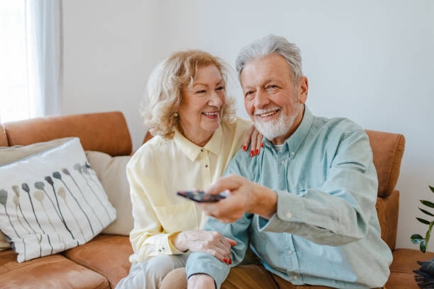 istock Senior couple at home watching TV 1322918340