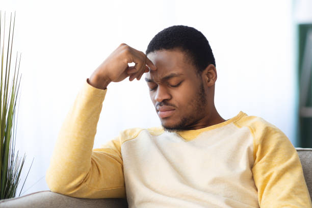 istock Upset black guy suffering from headache, closeup 1322918404