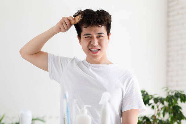 istock Asian handsome young guy in white t-shirt is combining with brush 1322918774