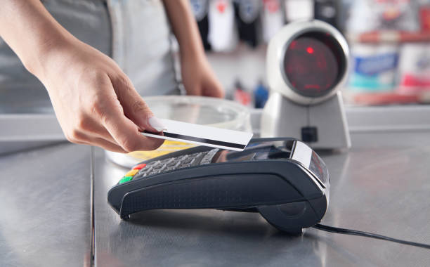 istock Customer making payment using credit card in a supermarket. 1322918913