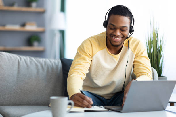 istock Positive black guy attending online training from home 1322919603