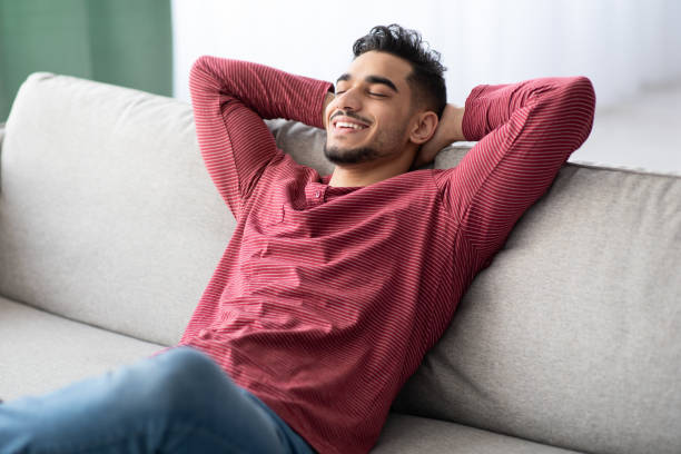 istock Happy middle-eastern guy in casual chilling at home 1322920158