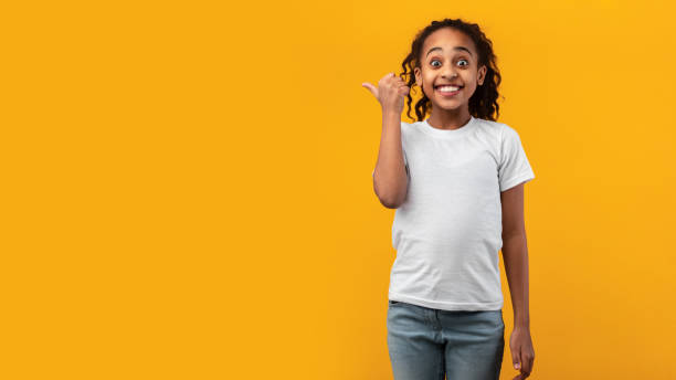 istock Excited girl pointing aside at free copy space 1322920278