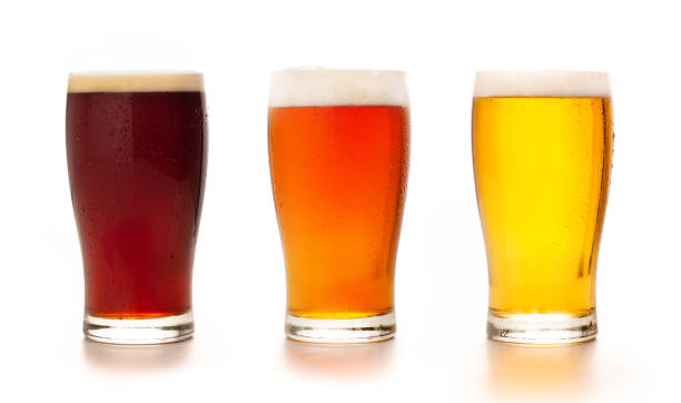 Different types of craft fresh drink. Assortment of beer in tall glasses Different types of craft fresh drink. Assortment of beer in tall glasses. Light, barley and dark lager in glasses, isolated on white background, mockup, studio shot, close up, free space glass of beer stock pictures, royalty-free photos & images