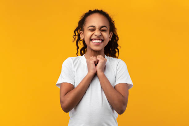 istock Hopeful african american girl making wish at studio 1322920928