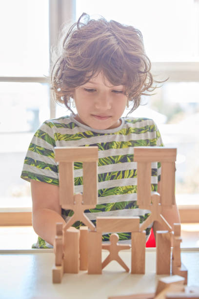 istock Cute little boy Playing with Wooden Blocks 1322920981