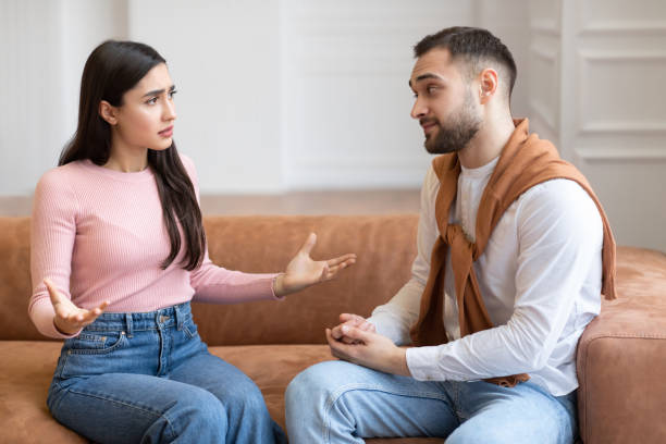 istock Discontented Wife Talking To Husband Having Quarrel Sitting At Home 1322921416