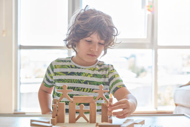 istock Cute little boy Playing with Wooden Blocks 1322922116
