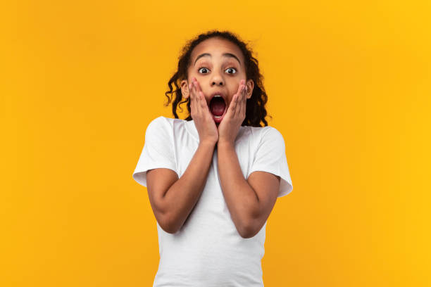 istock Wow. Excited black girl touching her face 1322922210