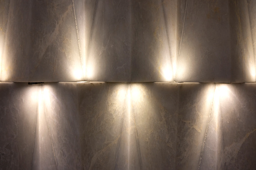 Simple modern decoration with LED lights on a concrete wall.