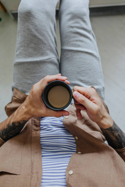 istock Anonymous Man Sitting and Enjoying a Cup of Coffee, From Above 1322923404