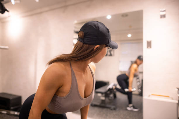 istock Young female athlete checking her mustle in the mirror 1322924472