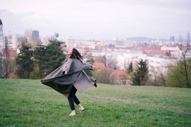 istock Young runs and dances through city park 1322924547