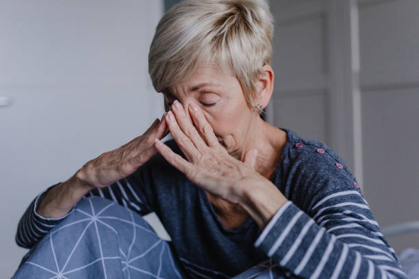 istock Senior woman is having a headache at home 1322924670