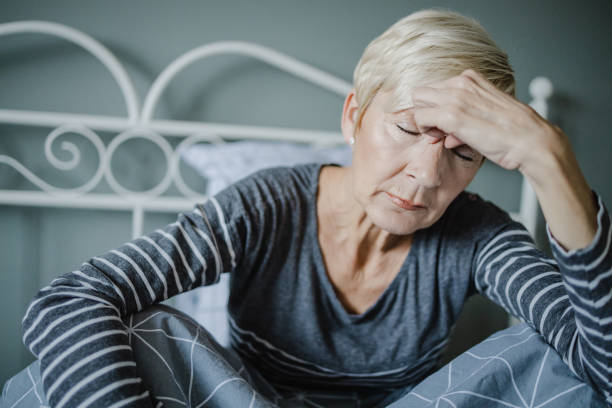 istock Senior woman is having a headache at home 1322924841