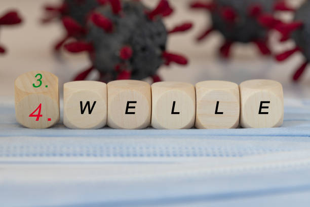 istock wooden cubes with the German word third or fourth wave 1322924867