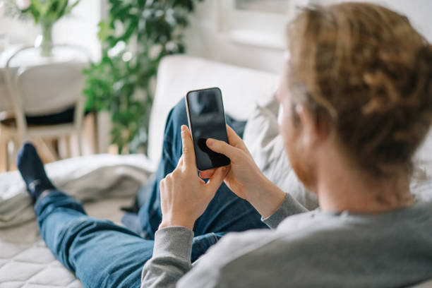 istock Young man relaxes in living room during quarantine 1322926543