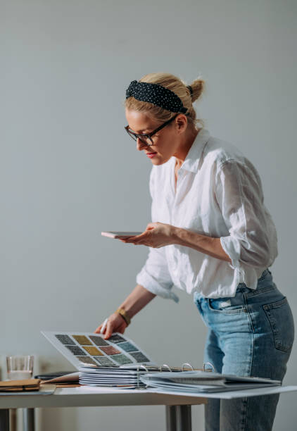 istock Young Woman Choosing Colour Palette For New Home Using Mobile 1322927653