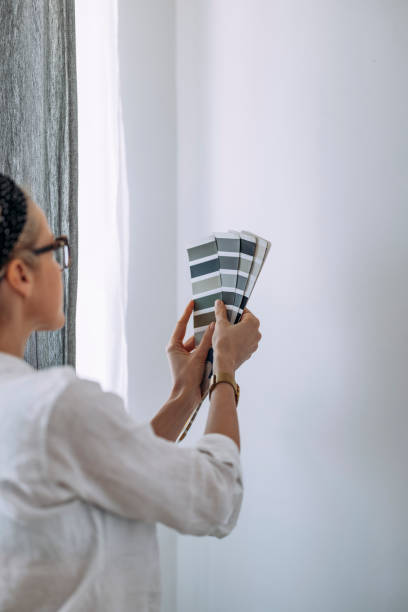 istock Young Woman Holding Colour Chart On White Wall 1322927672