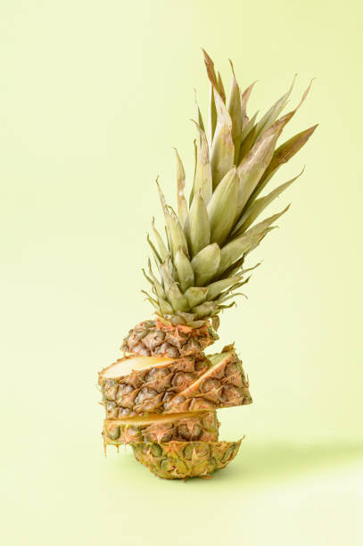 istock Pineapple cut into several pieces on a green background. Summer concept of refreshing fruit 1322928769