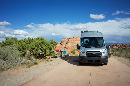 Moab, Utah - May 10, 2021: Camper van parked in campsite in Arches National Park campground just outside Moab, Utah.
