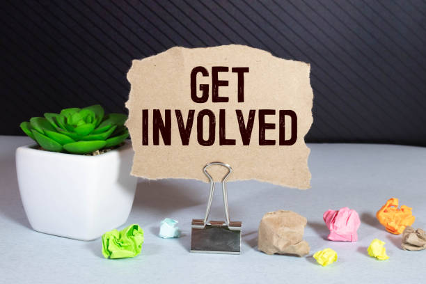 istock Get Involved Text written on notebook page, red pencil on the right. Motivational Concept image 1322934076