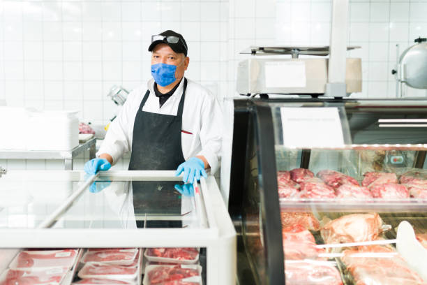 istock Mature man working at the grocery shop 1322934790