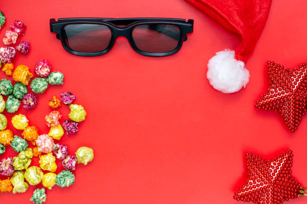 istock Pop corn and 3d glasses, holiday decorations on red background. Christmas concept 1322942667