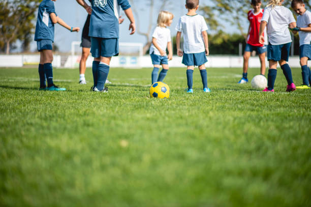 istock Mixed Age Range Footballers Practicing Dribbling and Passing 1322942678