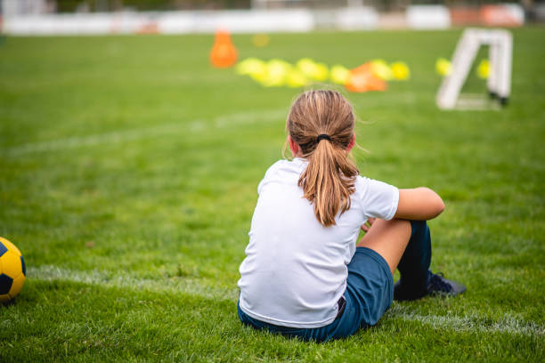 istock Young Female Footballer Sitting on Sideline During Practice 1322942711