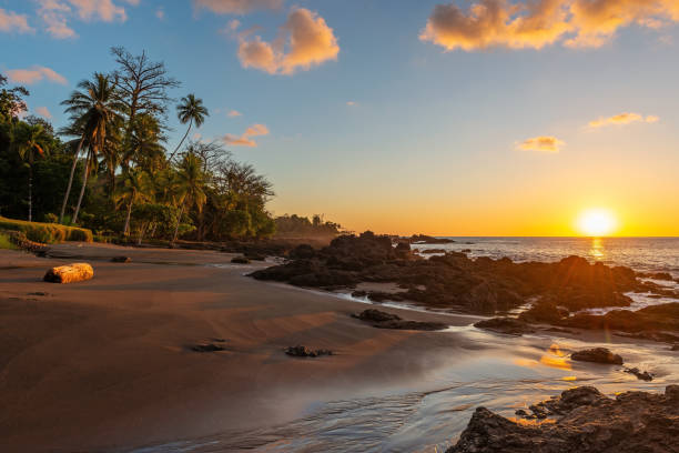 Beach Sunset, Corcovado national park, Costa Rica Corcovado national park sunset along Pacific Ocean beach, Costa Rica. costa rican sunset stock pictures, royalty-free photos & images