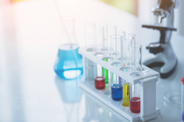 istock Microscope and colorful test tubes on table in Laboratory. Science chemistry concept. Blue tone 1322949323
