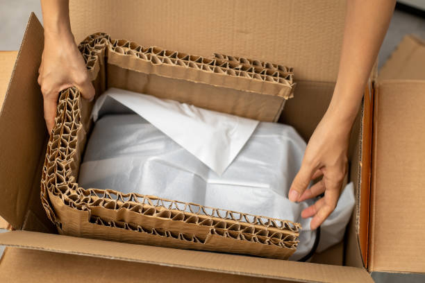 istock Cropped woman hands unpacking a carton box 1322953365