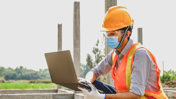 istock Engineer contractor man use lptop work safety industry project, check house plan design and investigating the size and quality in building construction structures site 1322956173